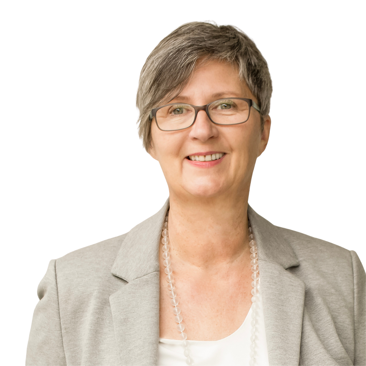 Monika Bröhl mit Excellence Awad Frau in orangefarbenem Mantel steht neben einer Auszeichnung.